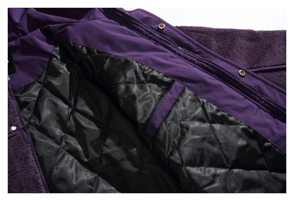 Inside of a purple jacket showing black quilted lining, a purple trim strip, and front closures.