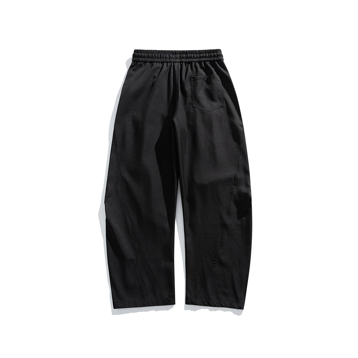 Back view of black loose straight-leg trousers with an elastic waistband and a single patch pocket.