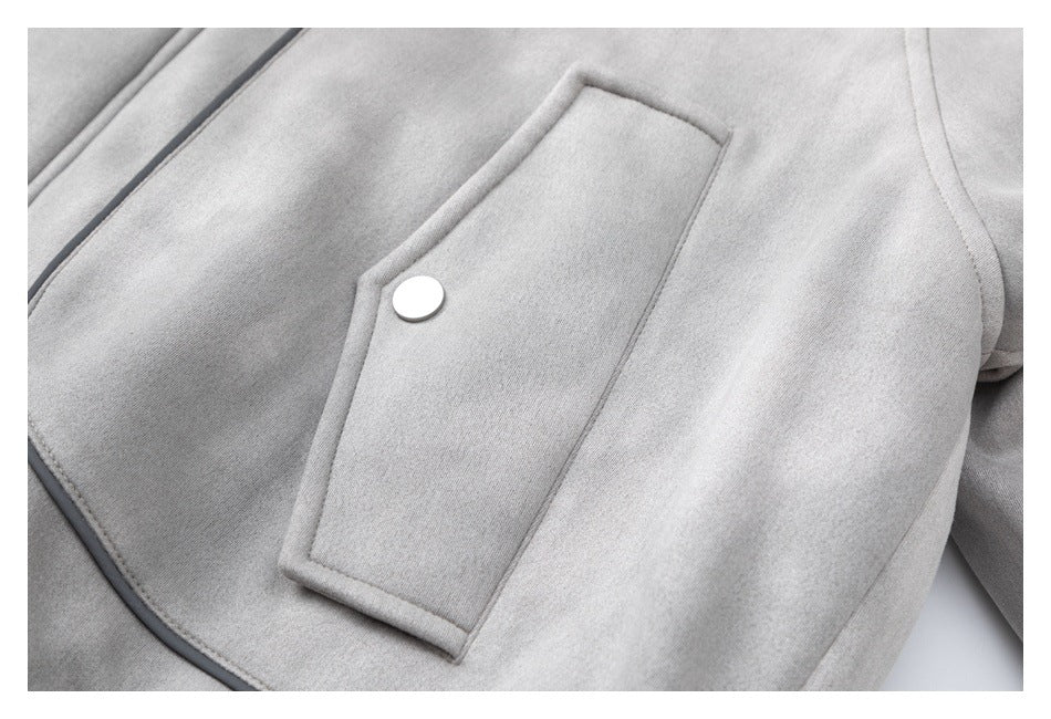 Close-up of a light gray jacket's flap pocket with a white snap and dark piping.