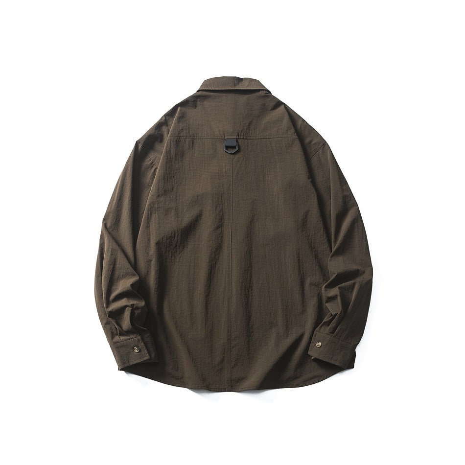 Back view of a dark brown long-sleeve button-up shirt laid flat, with a center seam and black loop detail.