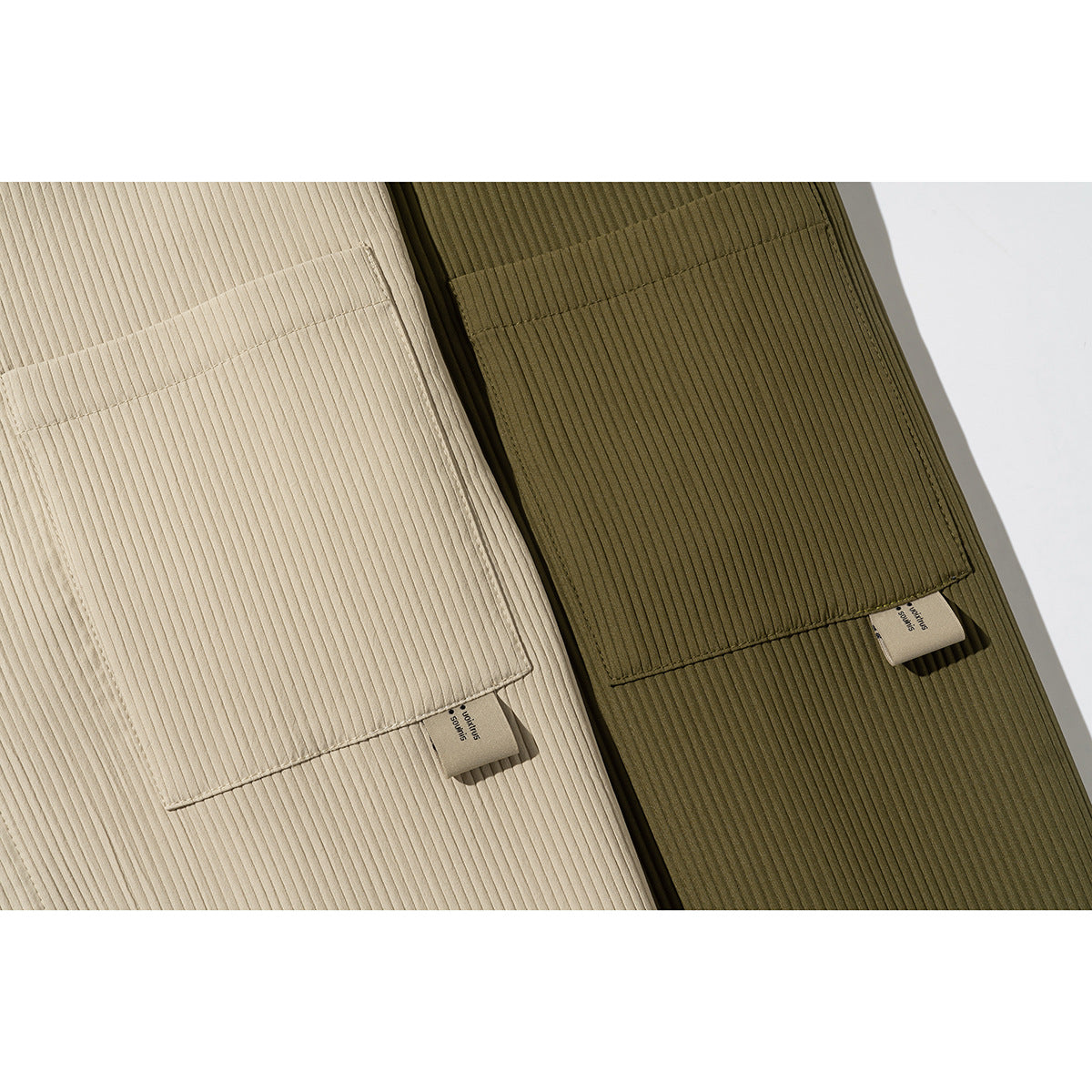 Close-up of chest pockets and ribbed fabric on beige and olive shirts.