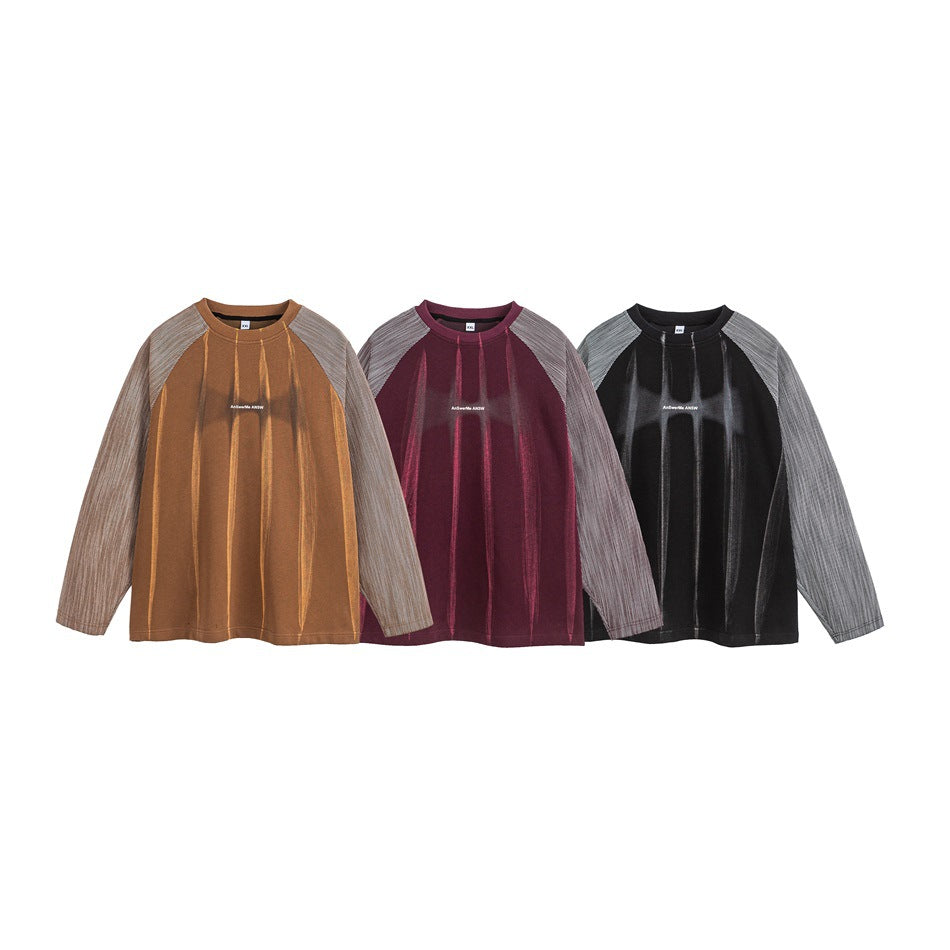 Three long-sleeved raglan tops shown in ochre, burgundy, and black, each with gray striped sleeves.