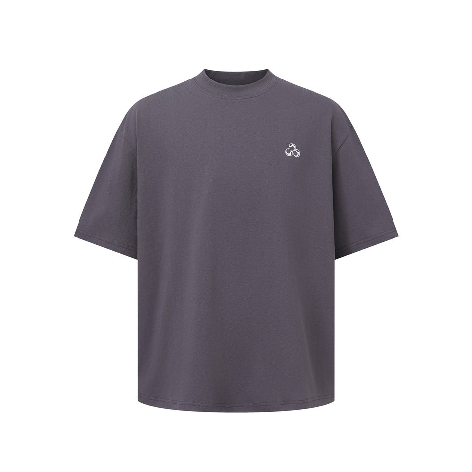 Front view of a charcoal-gray oversized short-sleeve T-shirt with a small white chest emblem.