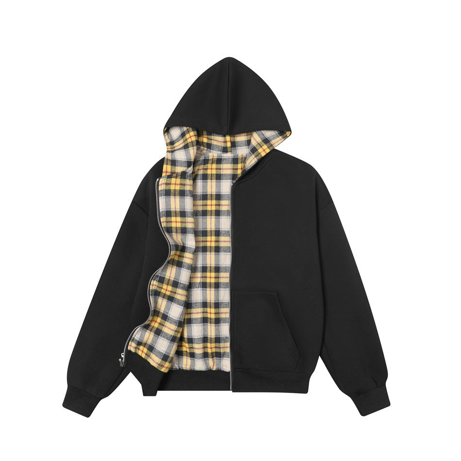 Black hooded jacket partly unzipped showing the yellow, black and cream plaid reverse side and plaid hood lining