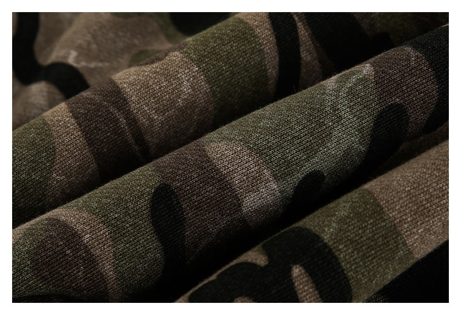 Close-up of the knit texture and camouflage pattern in dark green, brown, and black.