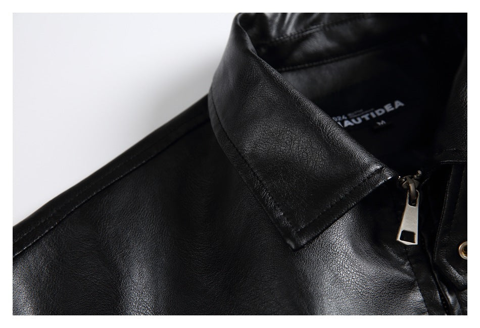 Close-up of a black jacket collar, zipper pull, and inner label.