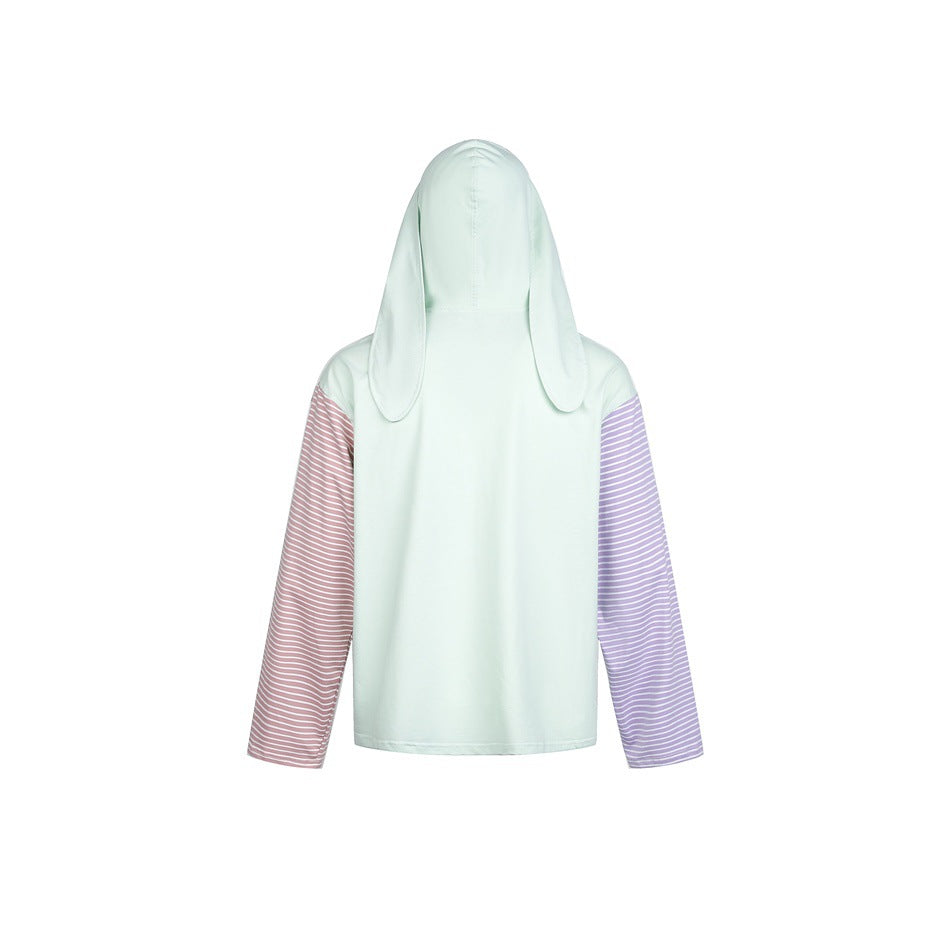 Back view of a pale mint hooded top with long floppy bunny ears and contrasting pink and lavender striped sleeves.