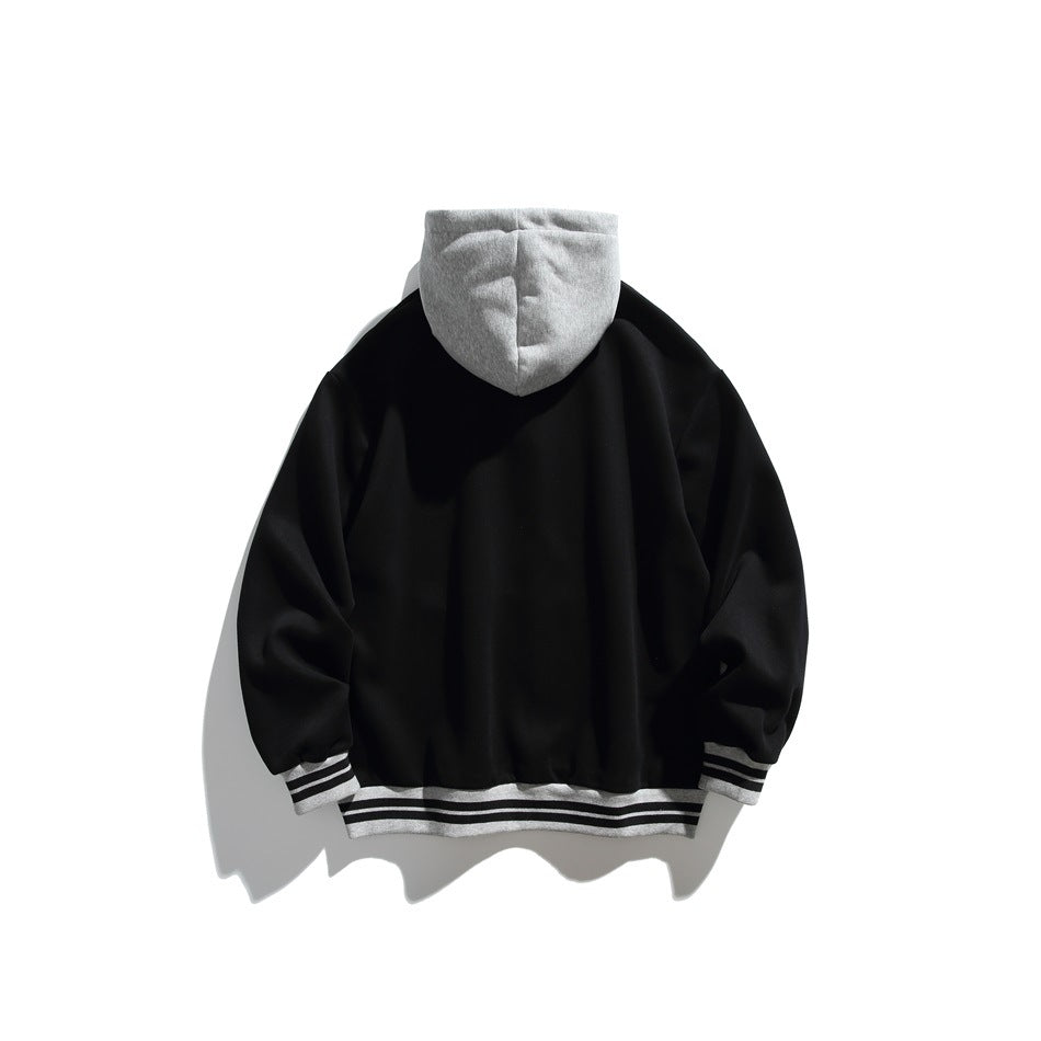 Back view of a black hoodie with a gray hood and gray-and-black striped cuffs and hem, displayed flat.