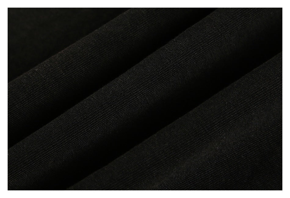 Close-up of black garment fabric draped into soft folds.