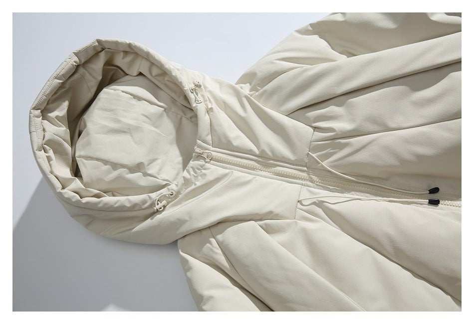 Close-up of the ivory jacket's hood, drawcords, and front zipper.