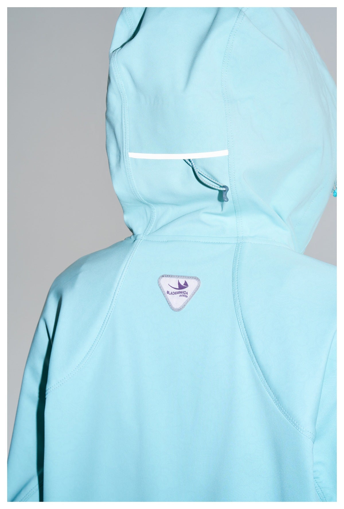 Close rear view of an aqua jacket showing the hood drawcord, back seams, and a small logo patch.