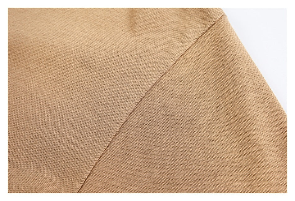 Close-up of the camel-brown T-shirt's sleeve and shoulder seam.