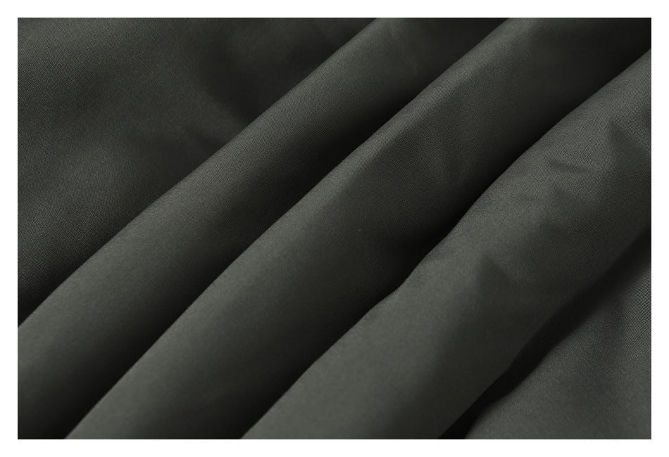 Close-up of dark gray jacket fabric arranged in soft folds.