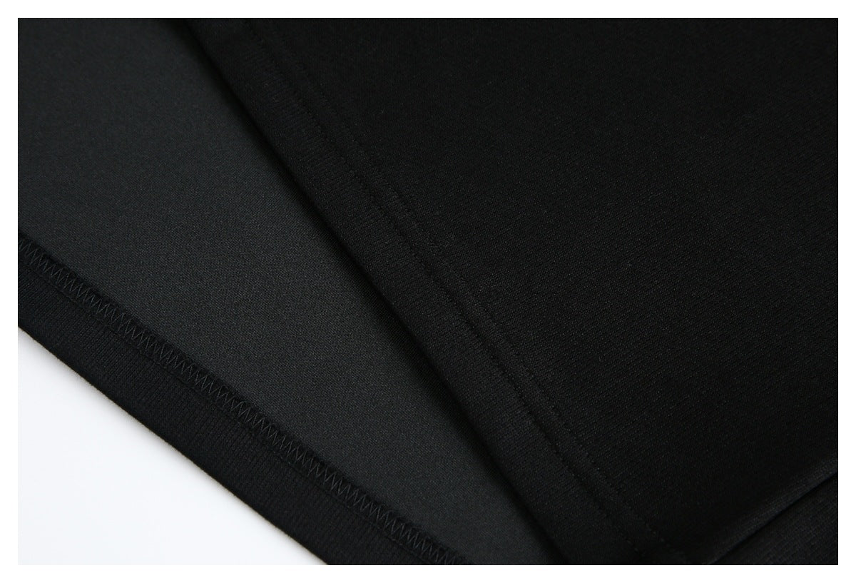Close-up of black garment stitching and a finished hem.