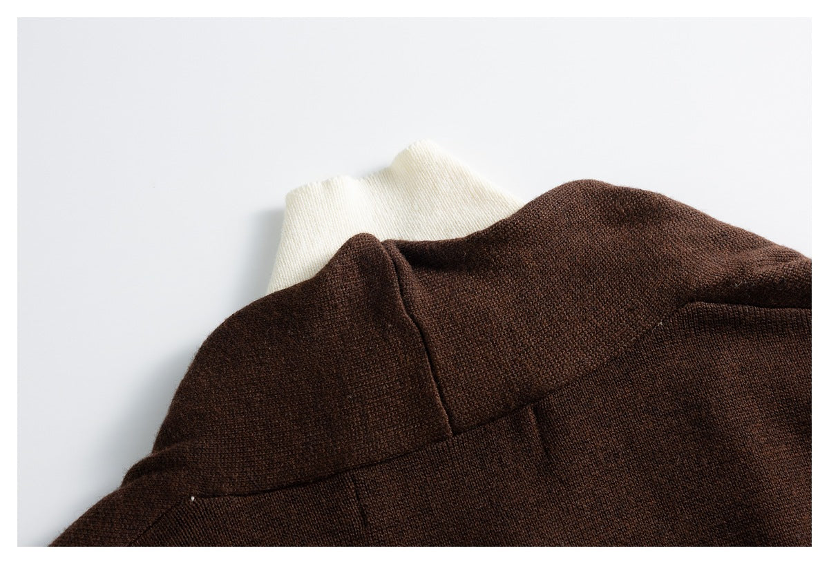Close-up of the dark brown cardigan's back collar and shoulder, with a cream layer underneath.
