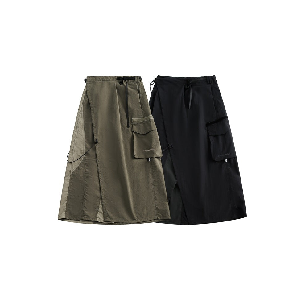 Two utility skirts shown side by side: one olive gray and one black, each with a waist drawcord and cargo pocket.