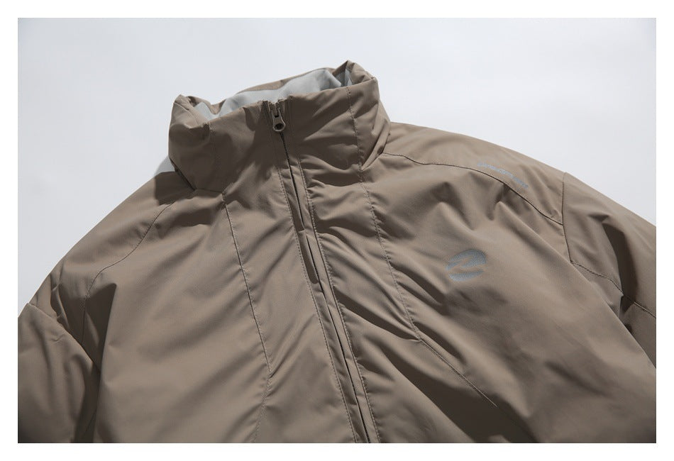 Close-up of the jacket’s raised collar, front zipper, shoulder seams, and small chest emblem.