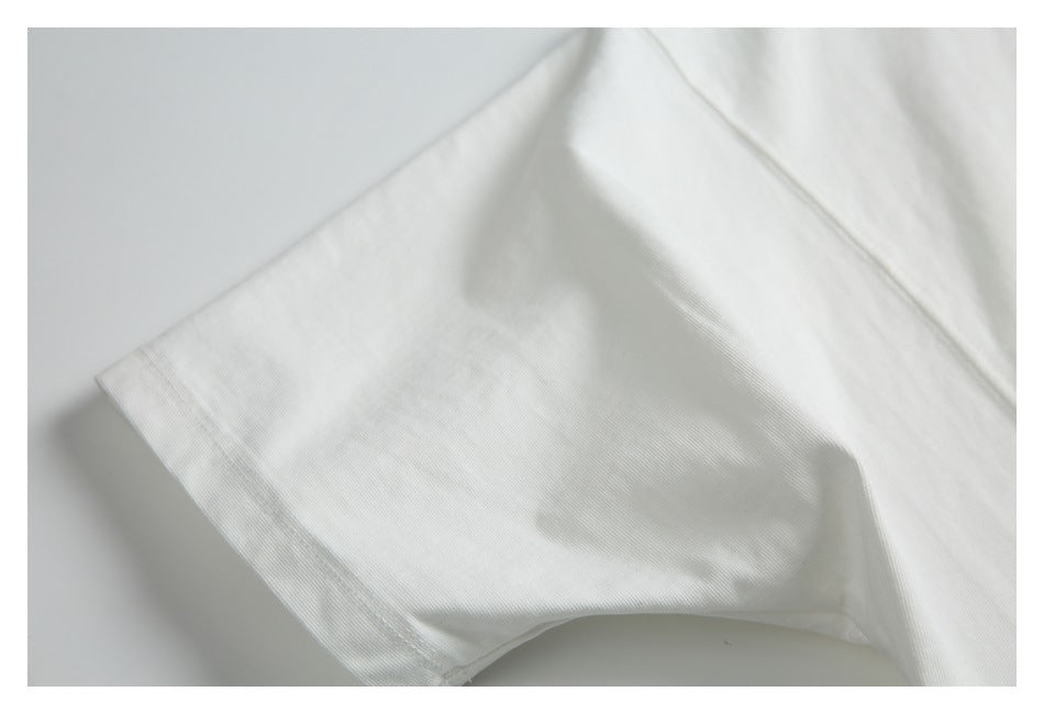 Close-up of a white garment sleeve and stitched cuff on a light background.