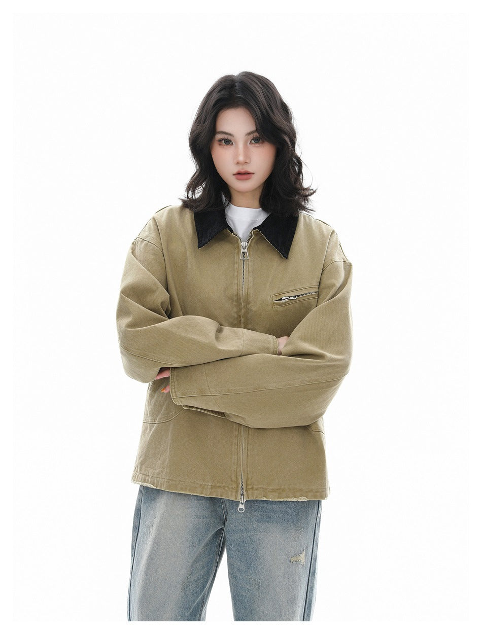 Model wearing a khaki jacket with black collar and chest zipper pocket, arms crossed over the front.
