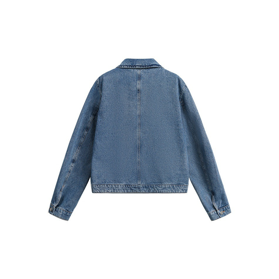 Back view of a blue denim jacket displayed flat, showing its center seam, collar, cuffs and hem.