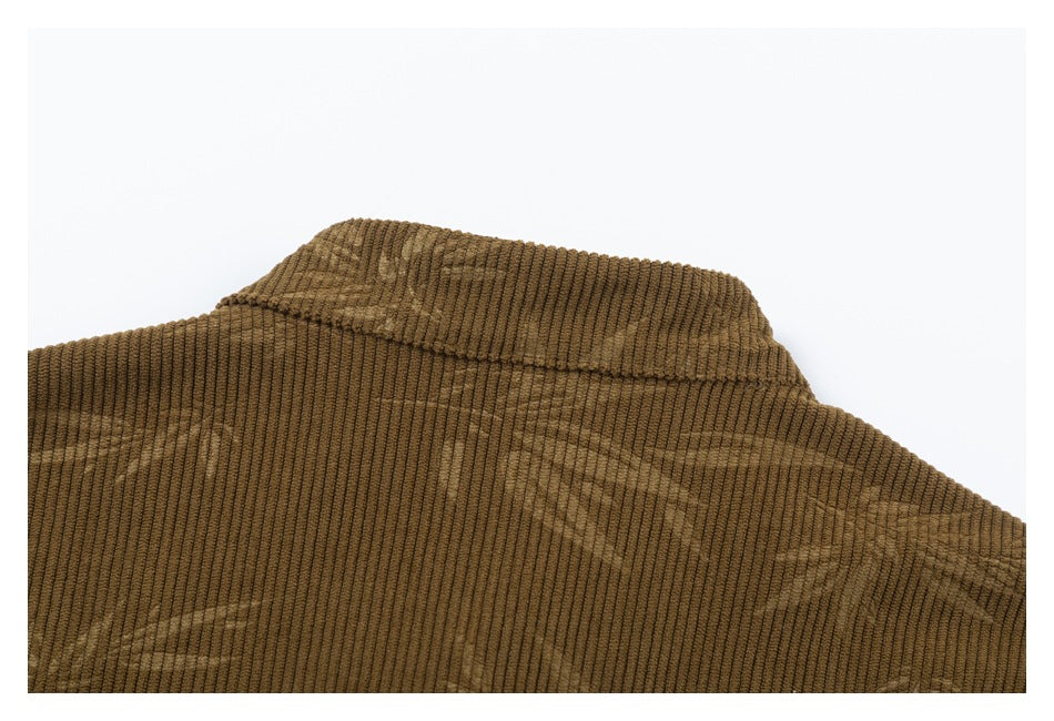 Close-up of the collar and upper back of a brown corduroy shirt with a subtle geometric pattern.