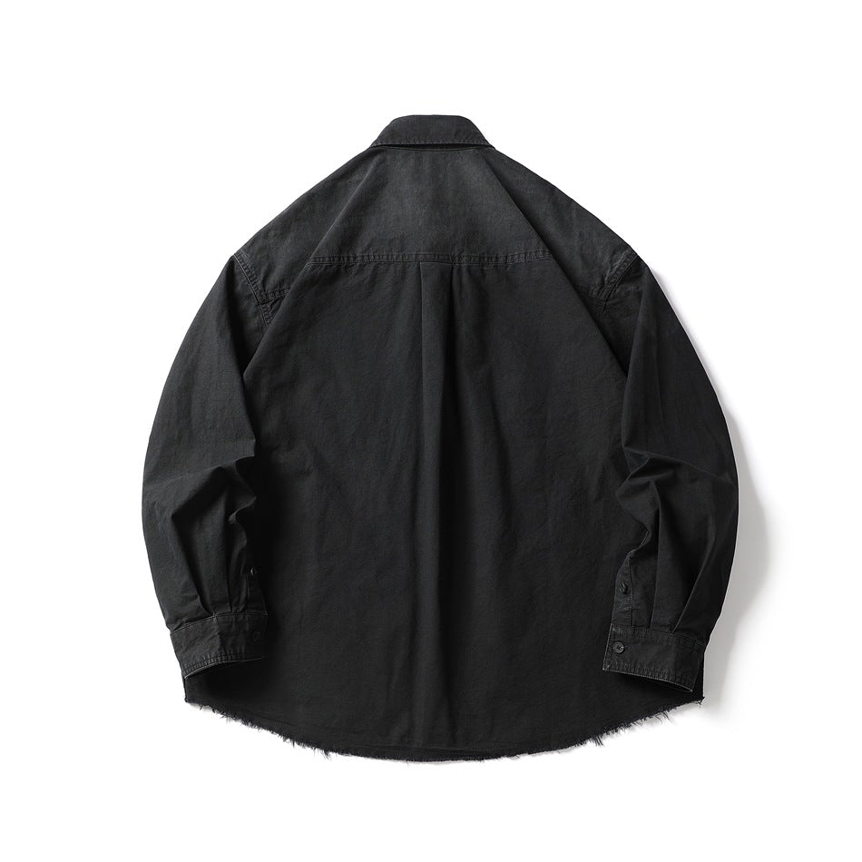 Back view of a black long-sleeve button-up shirt with a yoke seam, center pleat, button cuffs, and frayed hem.