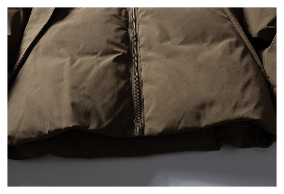 Close-up of a brown jacket's lower front, showing the center zipper and hem.