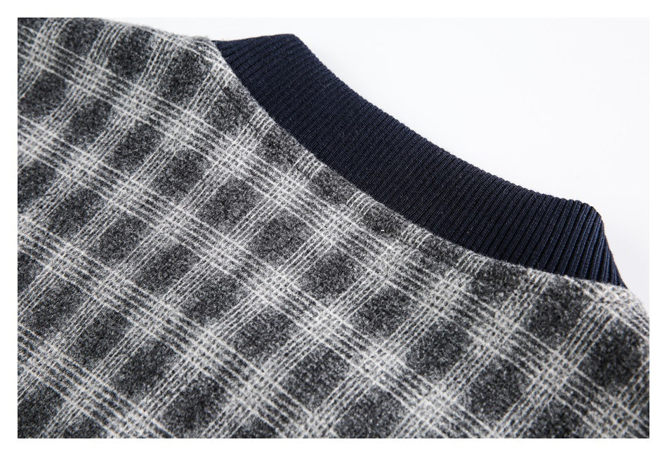 Close-up of a dark navy ribbed neckline against charcoal gray plaid fabric.