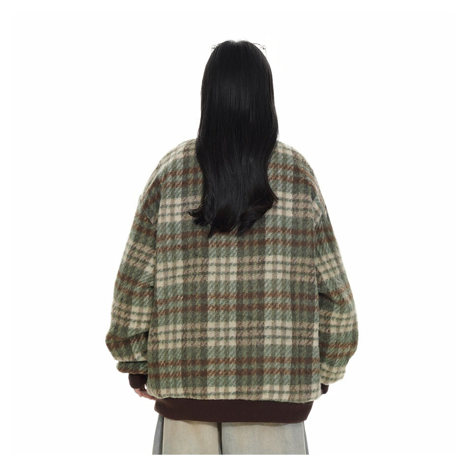 Rear view of a model wearing a green, cream, and brown plaid jacket with a dark brown ribbed hem.