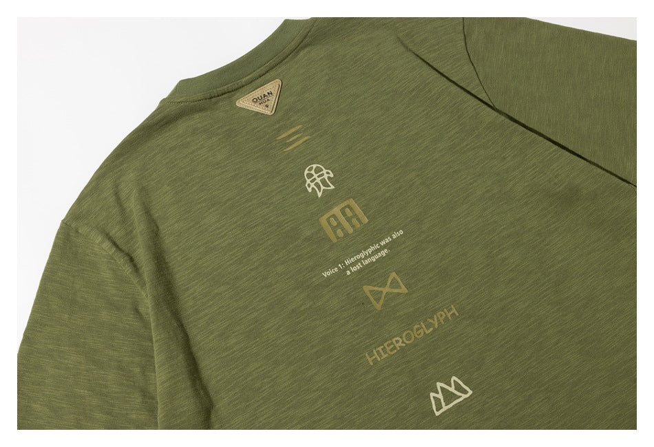 Close-up of the olive green T-shirt back with a vertical arrangement of small graphic symbols and English text.