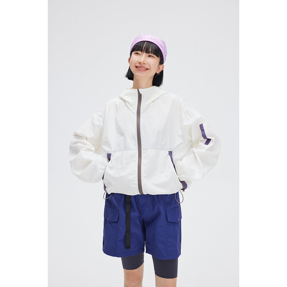 Model wearing a white hooded jacket with a gray front zipper and purple accents.