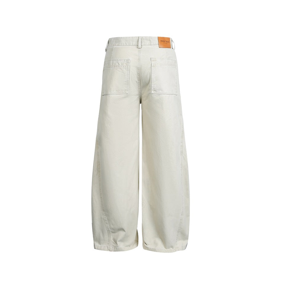 Back view of ivory wide-leg pants with two patch pockets and a tan waistband label.