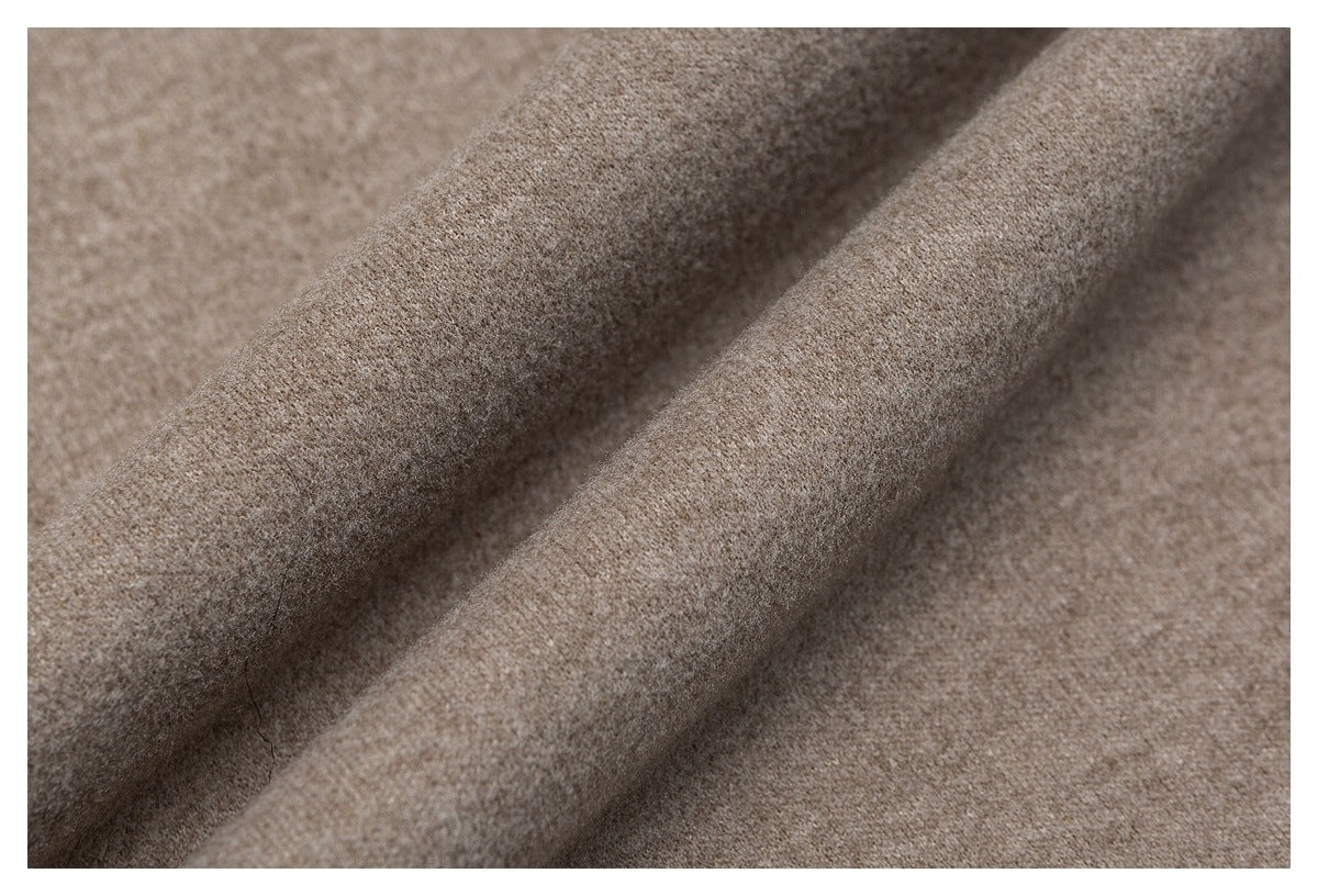 Close-up showing the soft, textured surface of taupe garment fabric.