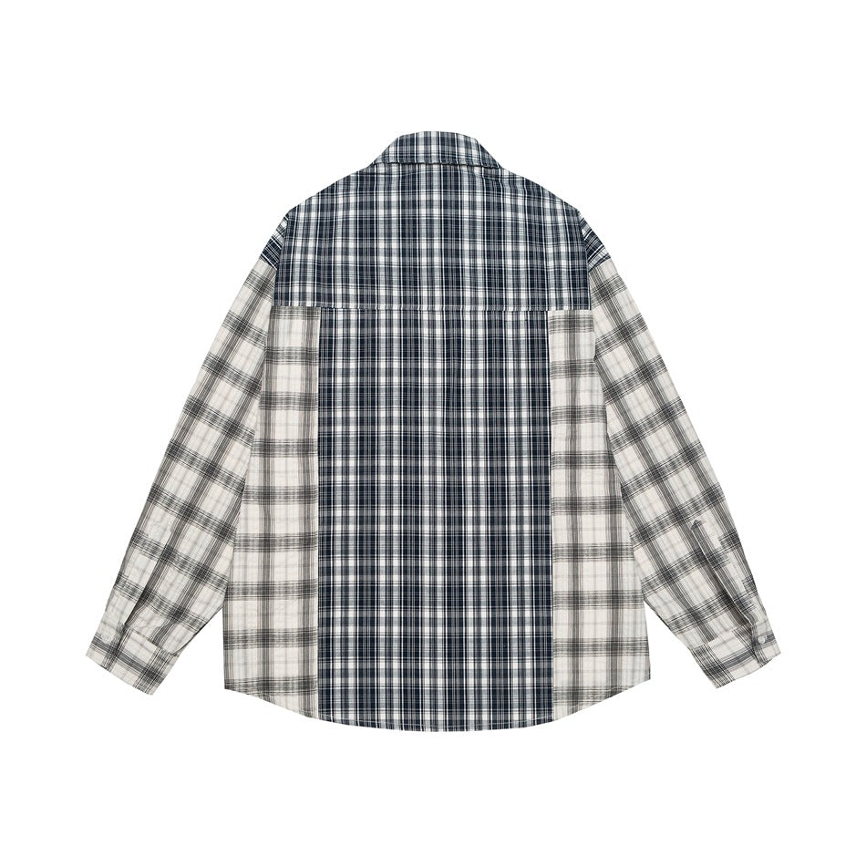Back view of a navy, black, and white plaid long-sleeve button-up shirt with contrasting panels.