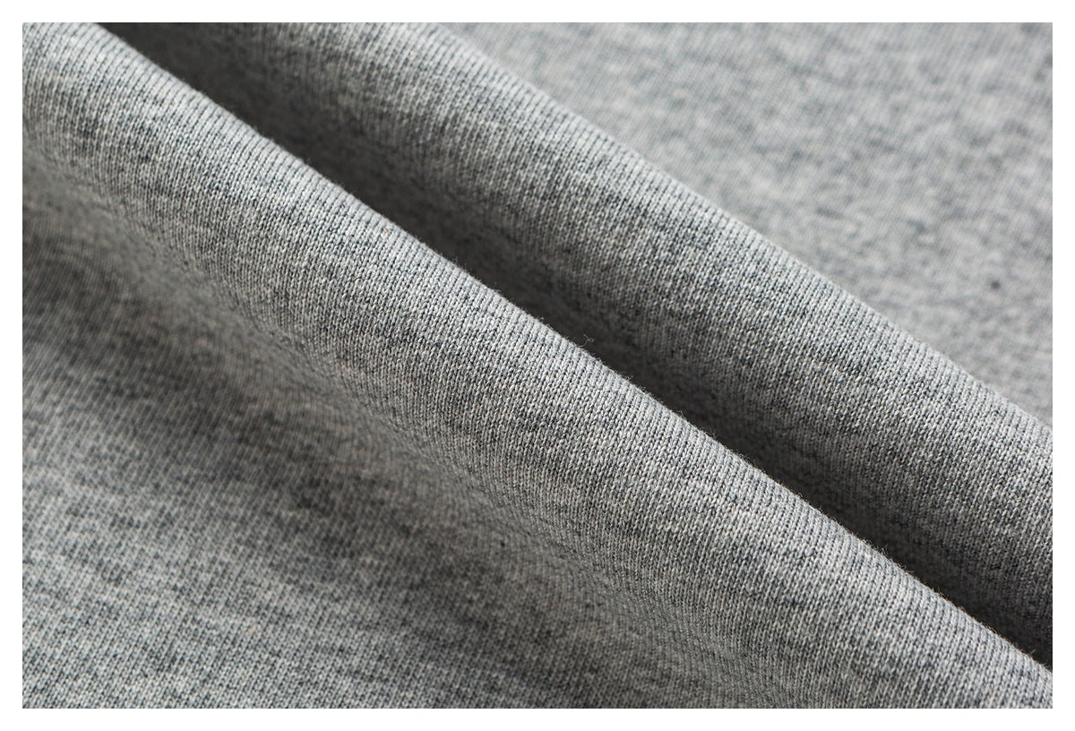 Macro view of heather gray knit fabric draped into soft folds.