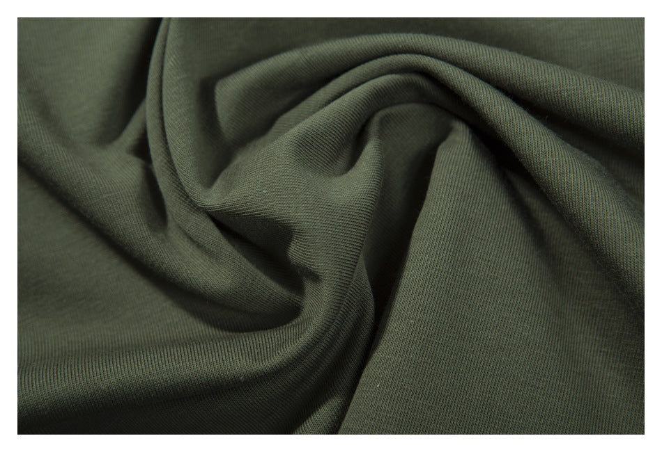 Close-up of the dark olive-green garment fabric gathered into folds.