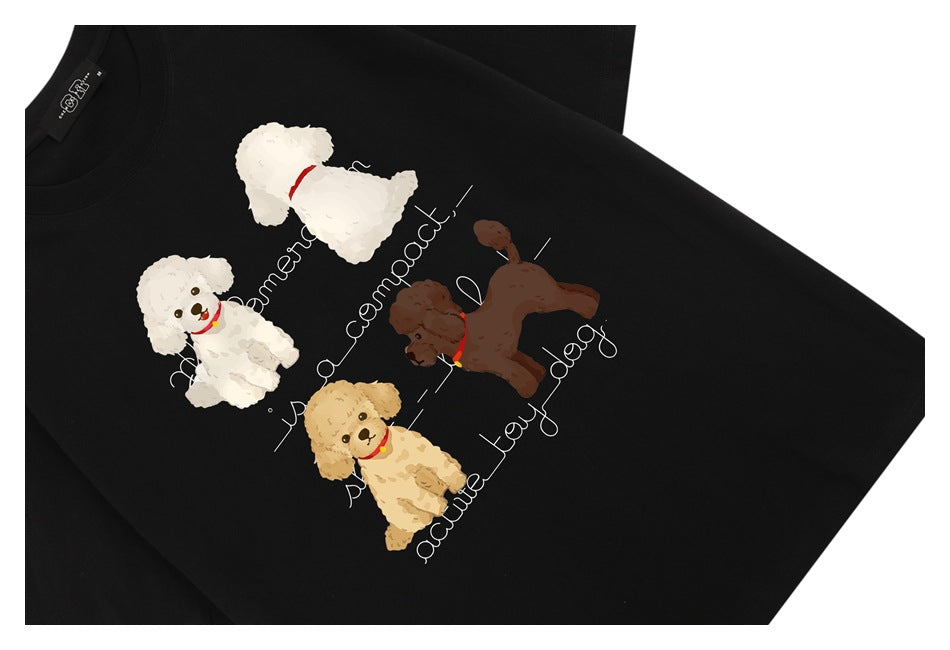 Black T-shirt close-up showing a printed design of four dogs with decorative English lettering.