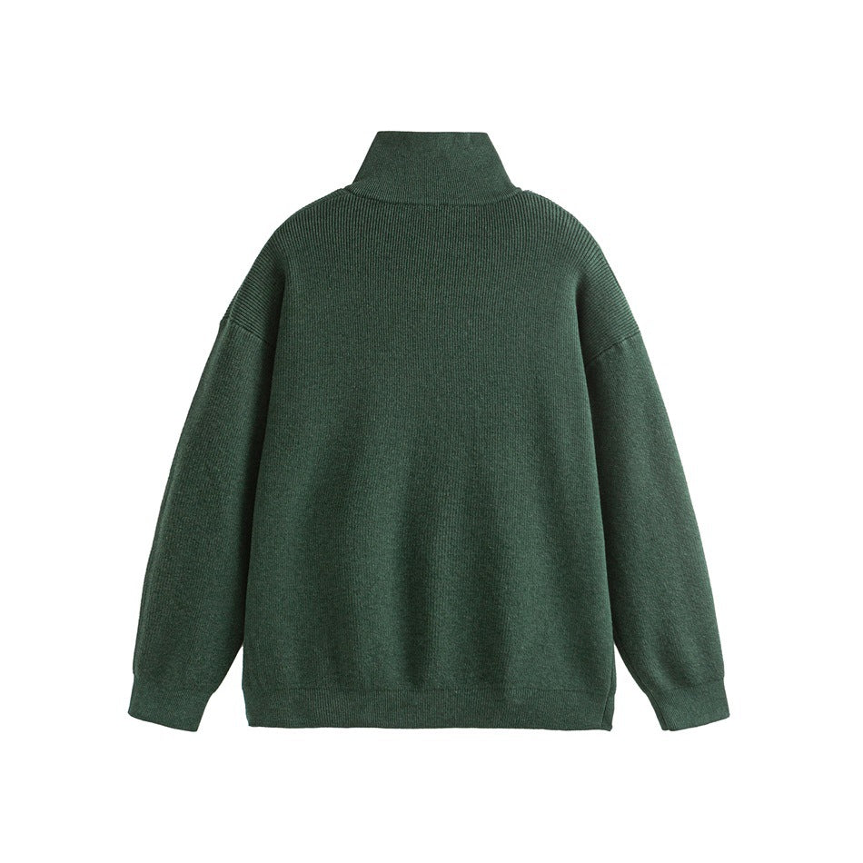 Back view of a dark green ribbed sweater with a high collar, long sleeves and ribbed hems.