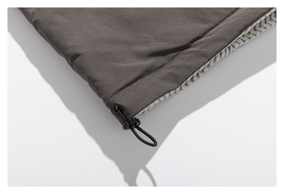 Close-up of the jacket hem showing a black adjustable drawcord toggle and patterned lining.