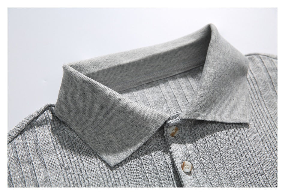 Close-up of the gray polo shirt's pointed collar and upper button placket.