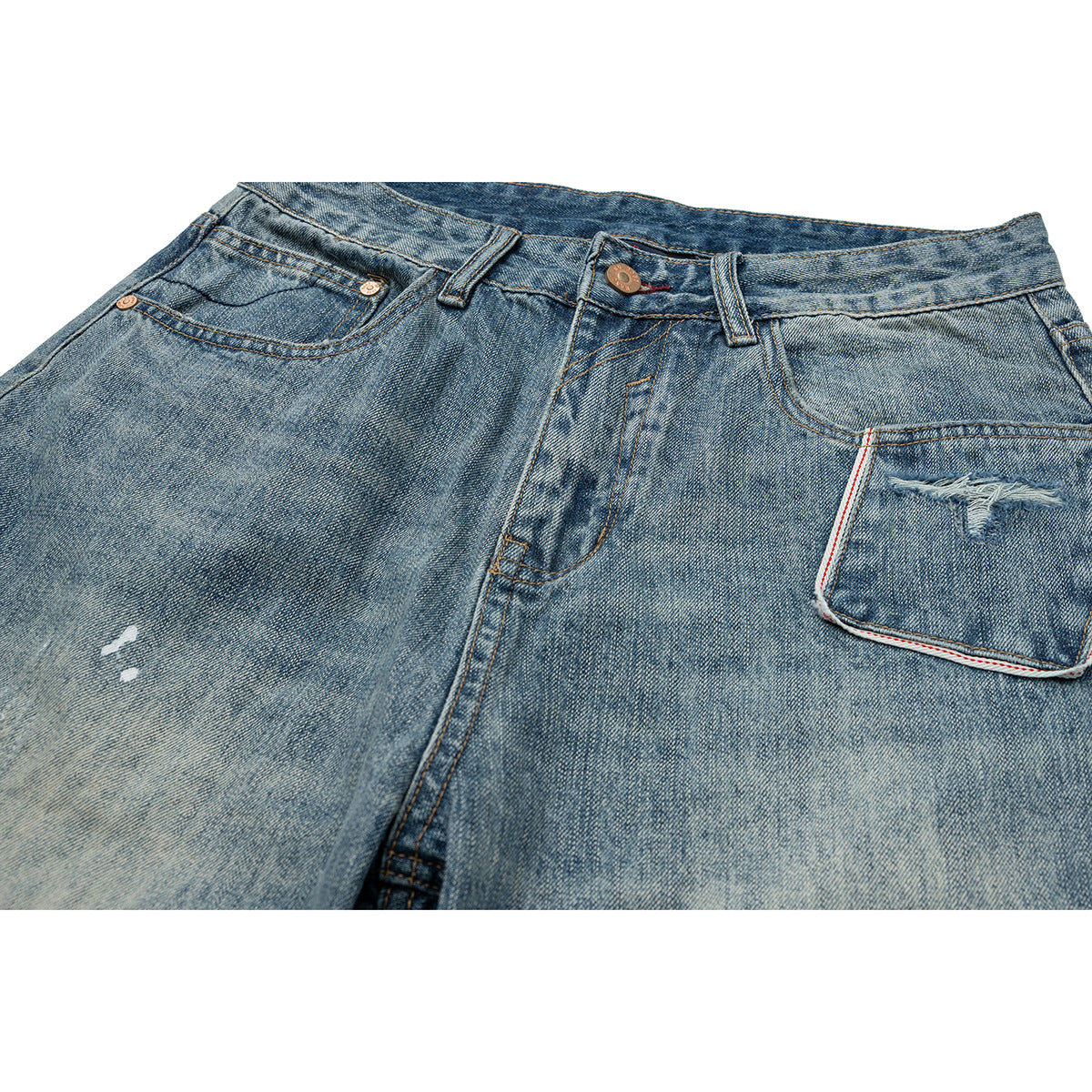 Close-up of faded blue jeans showing the front waistband, button, pockets, and a distressed coin pocket.