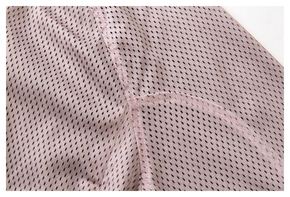 Close-up of the dusty mauve jacket's perforated fabric and stitched panel seams.