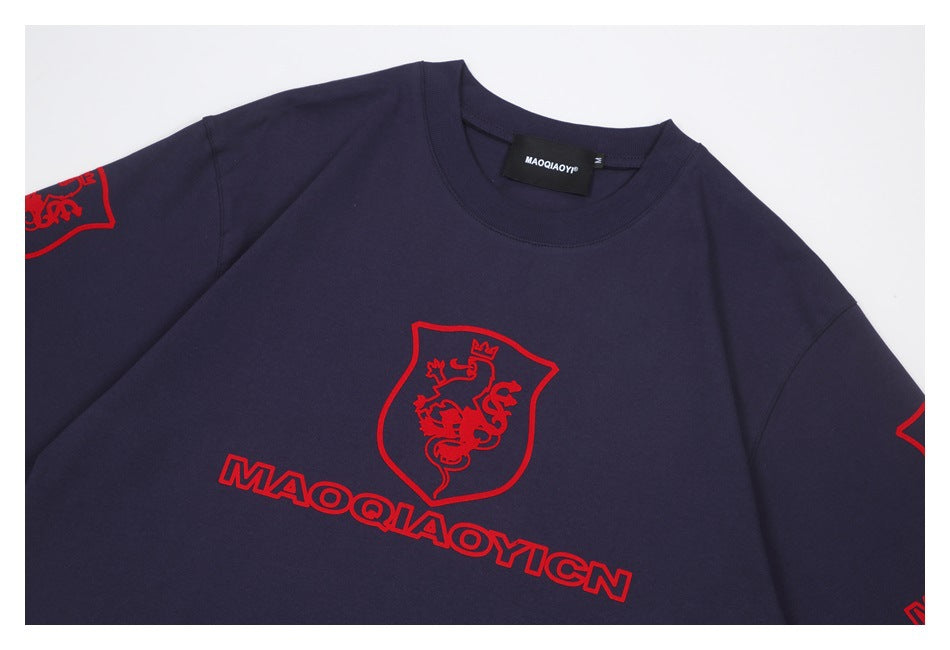 Close-up of a navy sweatshirt front with a red crowned-lion crest and outlined lettering.