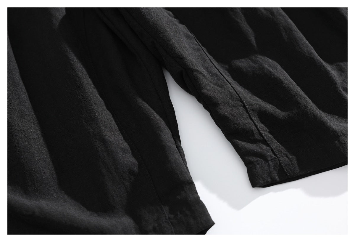 Close-up of black garment panels and finished edges against a white background.