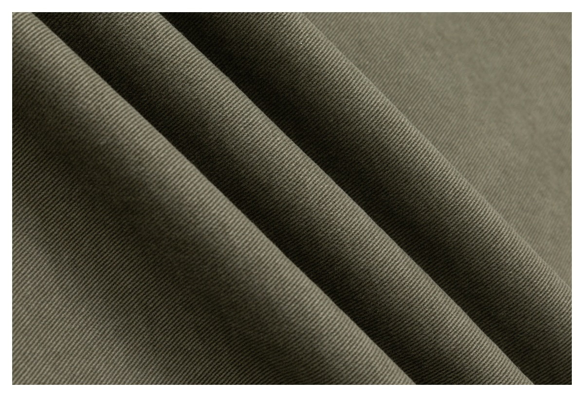 Close-up of olive-gray fabric folded to show its fine diagonal weave and texture.