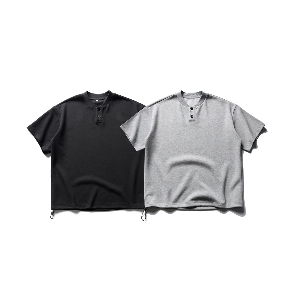 Two short-sleeve Henley shirts shown flat: one black and one heather gray, each with a short button placket and hem loops.
