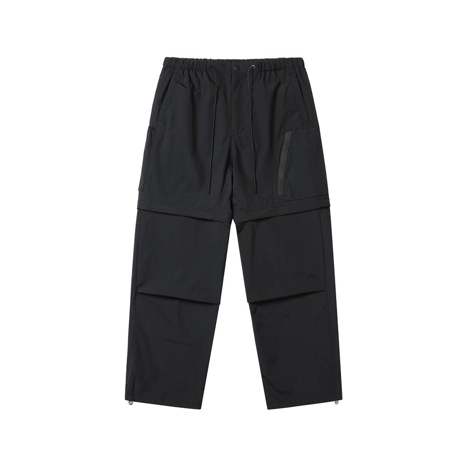 Black detachable cargo pants, front flat lay with drawstring waist, side pockets and toggle hems