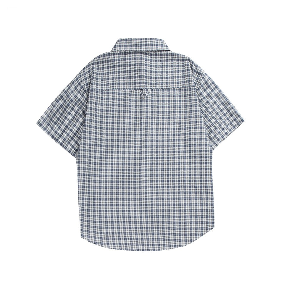 Back view of a short-sleeve collared shirt in blue, gray, and white plaid on a white background.