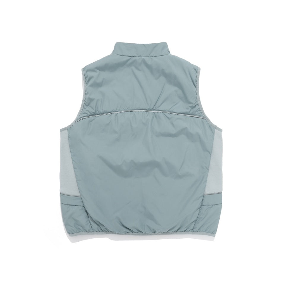 Back view of a pale sage sleeveless vest with a stand collar, light contrasting side panels, and subtle piping.
