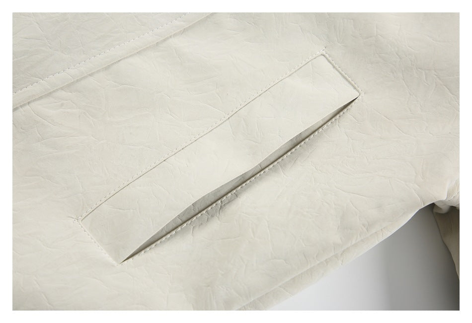 Close-up of a long angled welt pocket on the textured ivory jacket.